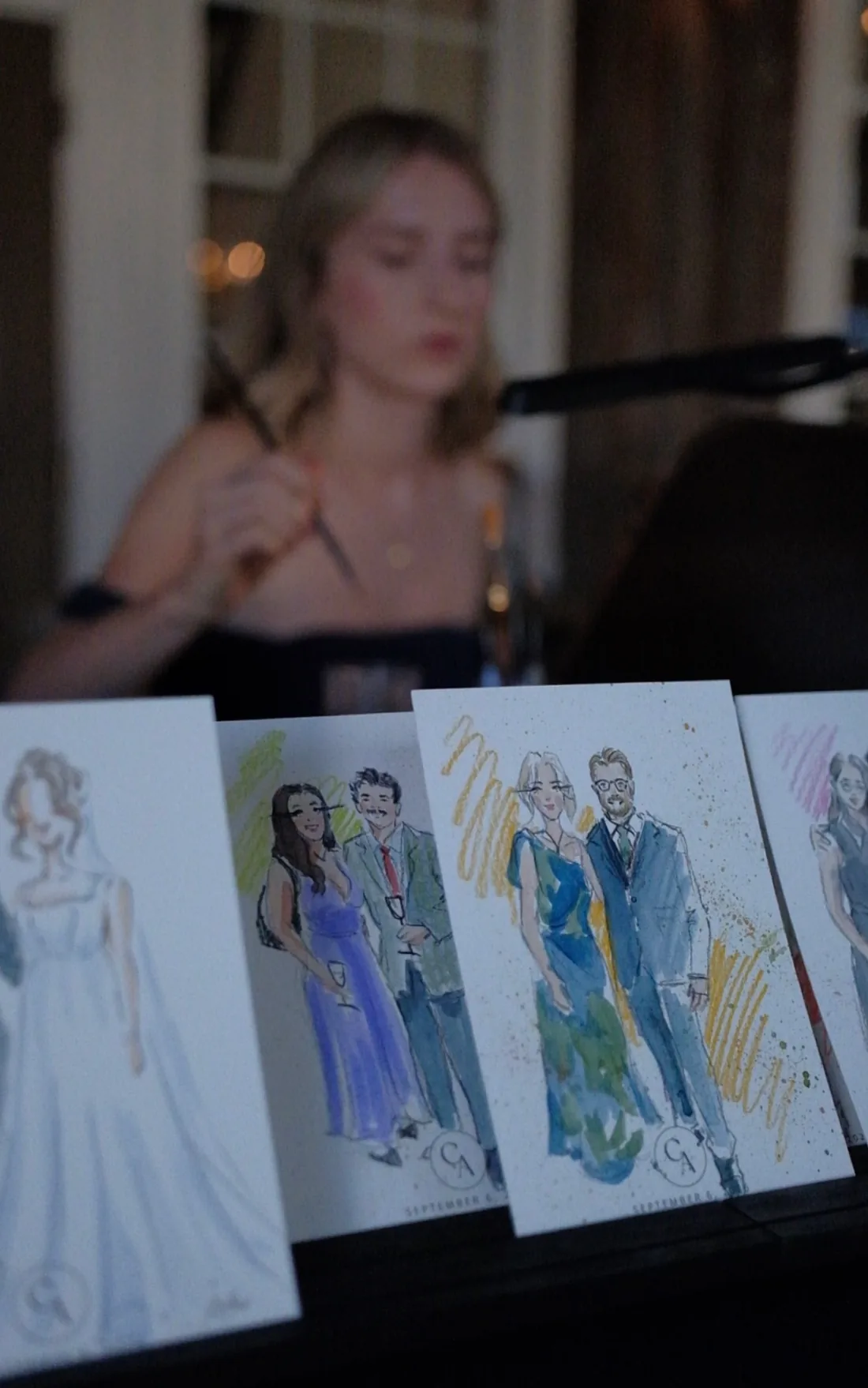 A display of finished live guest sketches at an event.